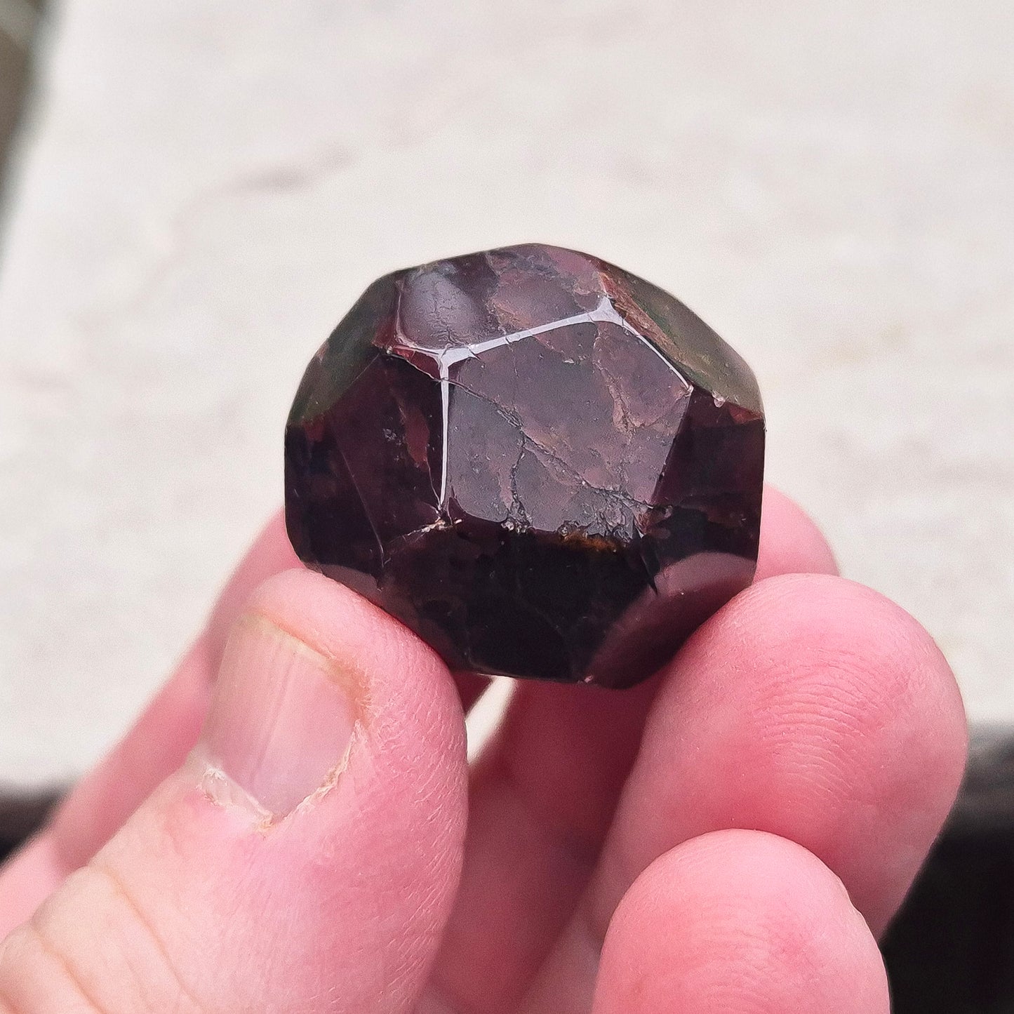 Almandine Garnet Crystal from India, featuring deep reddish-brown hues. Also known as Almandite, this variety of Garnet showcases rich colors ranging from dark reds to purple and brownish reds. 