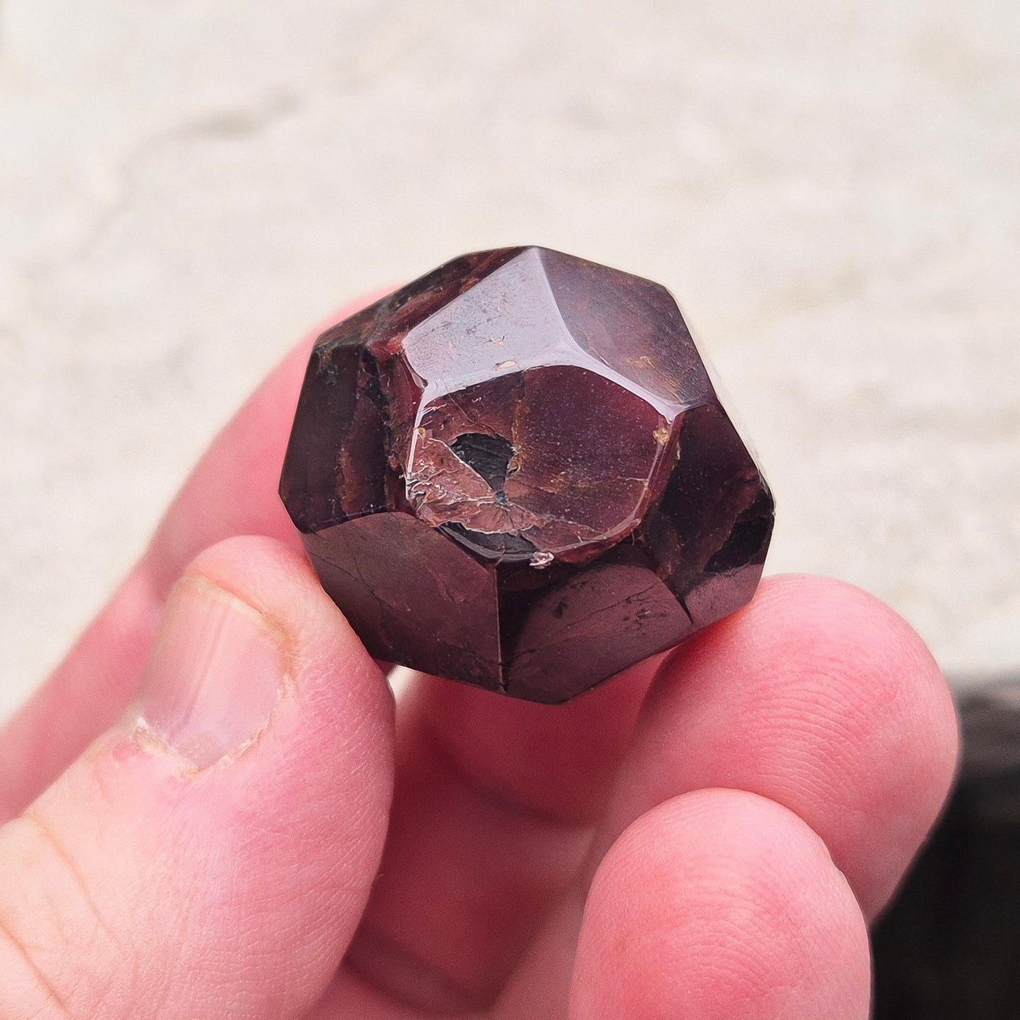 Almandine Garnet Crystal from India, featuring deep reddish-brown hues. Also known as Almandite, this variety of Garnet showcases rich colors ranging from dark reds to purple and brownish reds. 