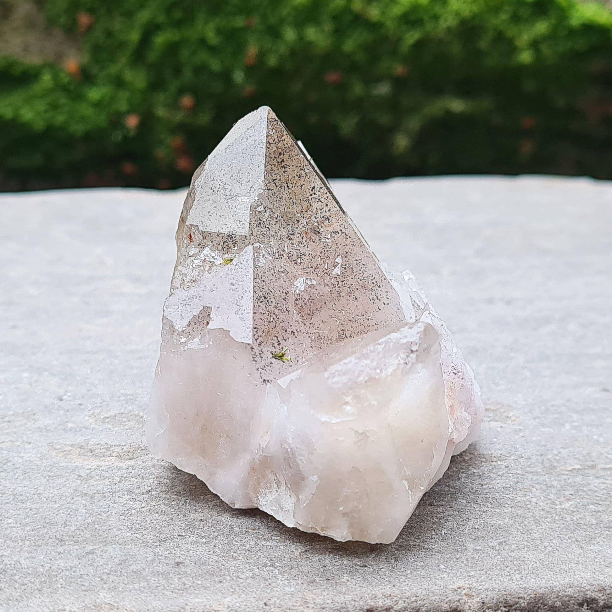 This beautiful Ametrine with Hematite Crystal Standing Point comes from China. A colour shines through in natural light, with a double polished tip, natural body, and a cut base. The addition of Hematite grounds Ametrine’s mental clarity and spiritual uplift, creating a deeply balancing and energising piece.