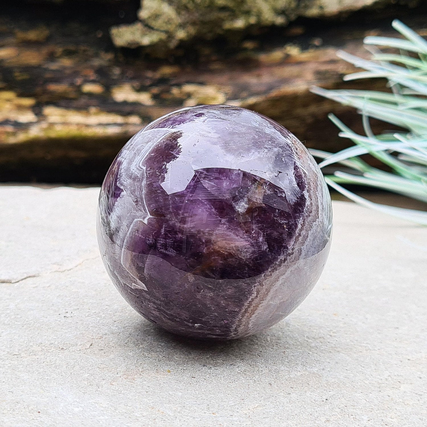 This Chevron Amethyst Crystal Sphere features natural banding of deep purple Amethyst and white Quartz. It’s a beautiful and distinctive piece—well-loved by those who feel drawn to crystals that evoke clarity and balance.