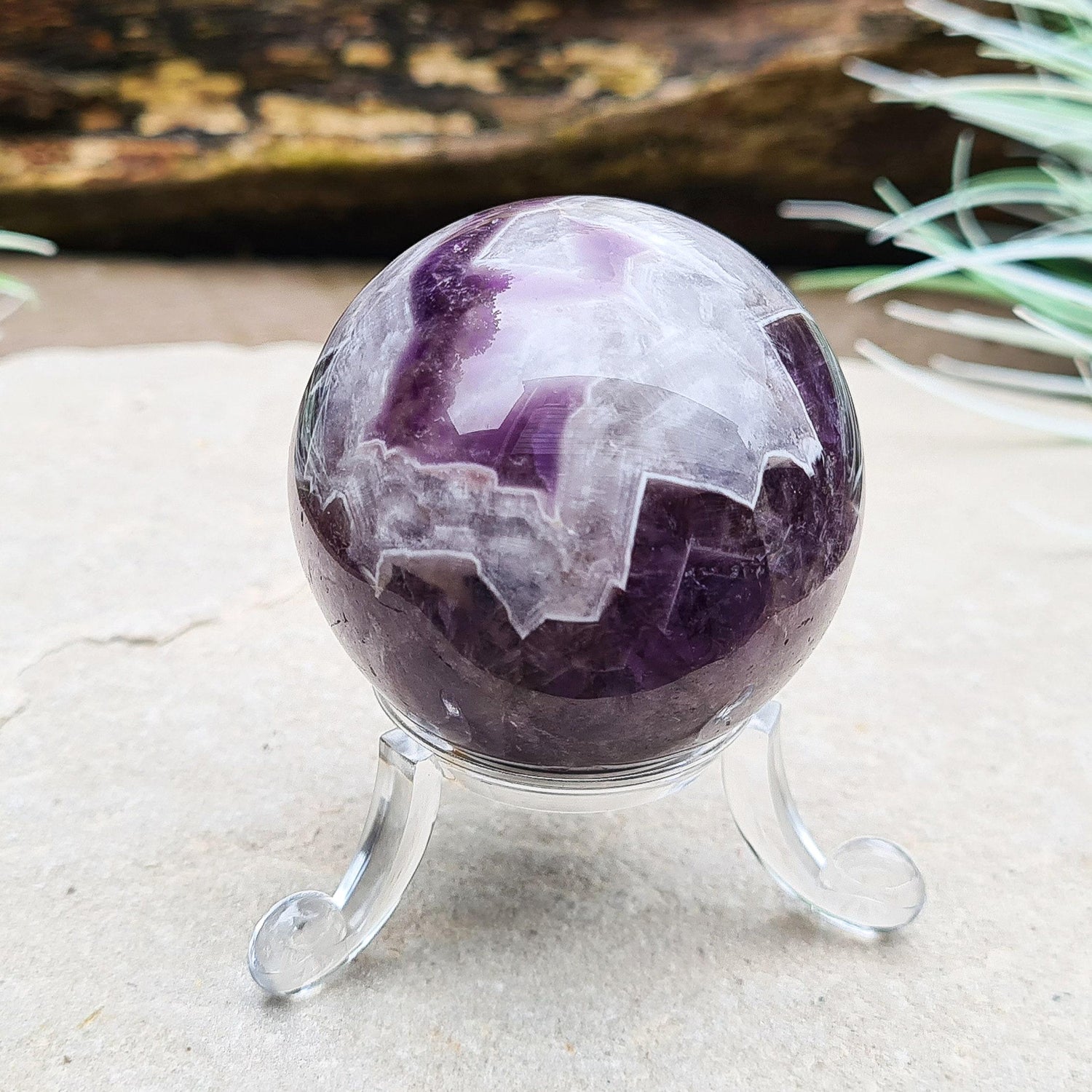 This Chevron Amethyst Crystal Sphere features natural banding of deep purple Amethyst and white Quartz. It’s a beautiful and distinctive piece—well-loved by those who feel drawn to crystals that evoke clarity and balance.