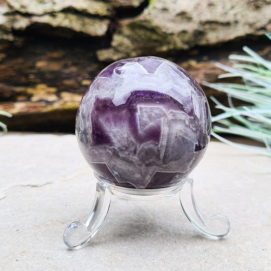 This Chevron Amethyst Crystal Sphere features natural banding of deep purple Amethyst and white Quartz. It’s a beautiful and distinctive piece—well-loved by those who feel drawn to crystals that evoke clarity and balance.