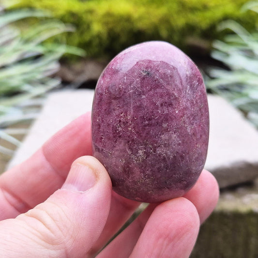 Rhodonite Crystal Pebble, Zimbabwe. Lovely Pink colouring with some black patches caused by the oxidation of Manganese.