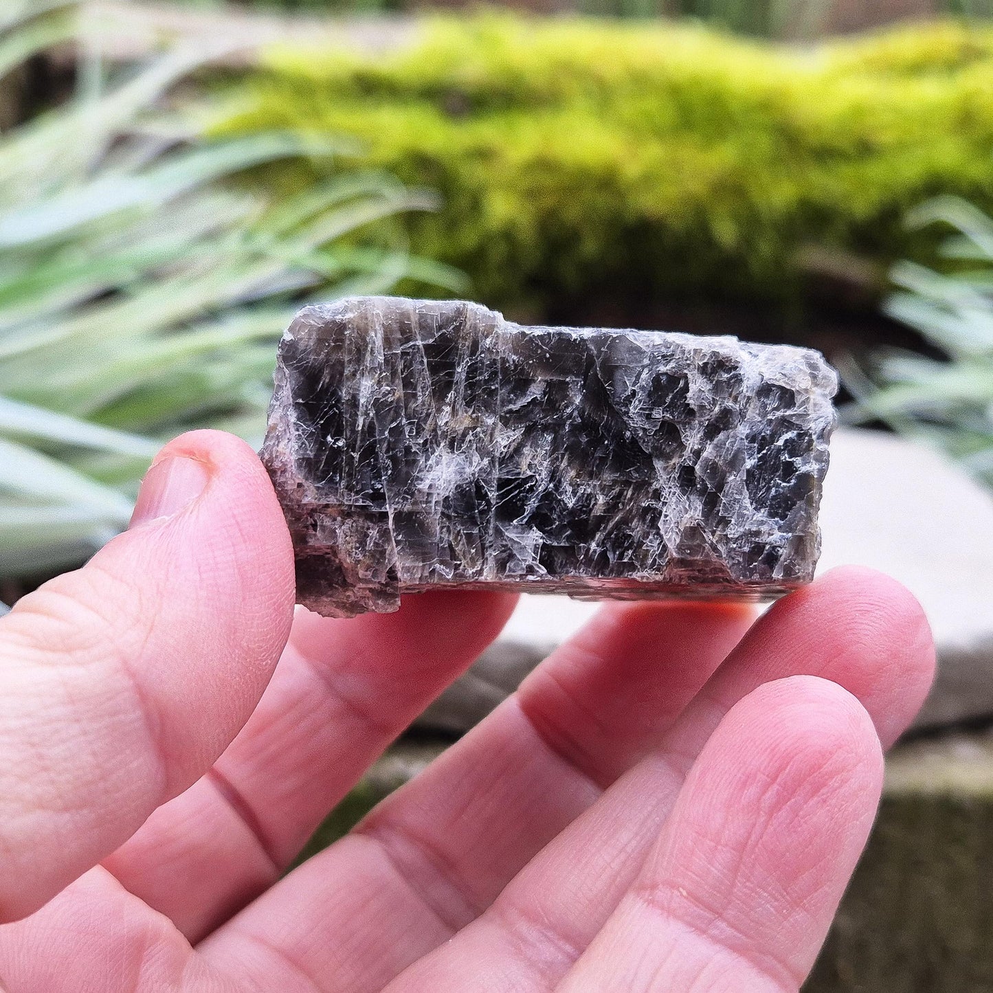 Black Moonstone from Madagascar, natural piece. Black Moonstone is a variety of moonstone that features dark shades, often with a subtle shimmer. It is typically found in deep gray, black, or brown hues with flashes of silver, peach, or white.