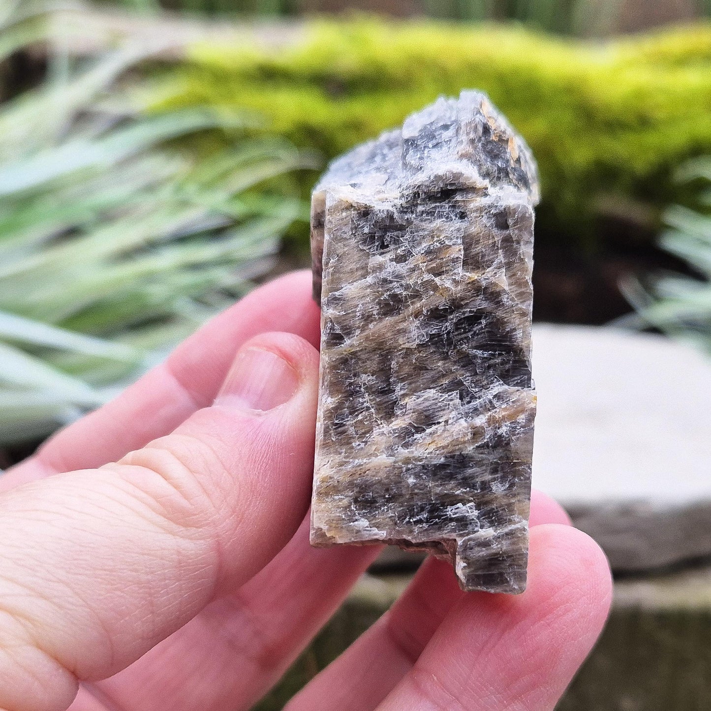 Black Moonstone from Madagascar, natural piece. Black Moonstone is a variety of moonstone that features dark shades, often with a subtle shimmer. It is typically found in deep gray, black, or brown hues with flashes of silver, peach, or white.