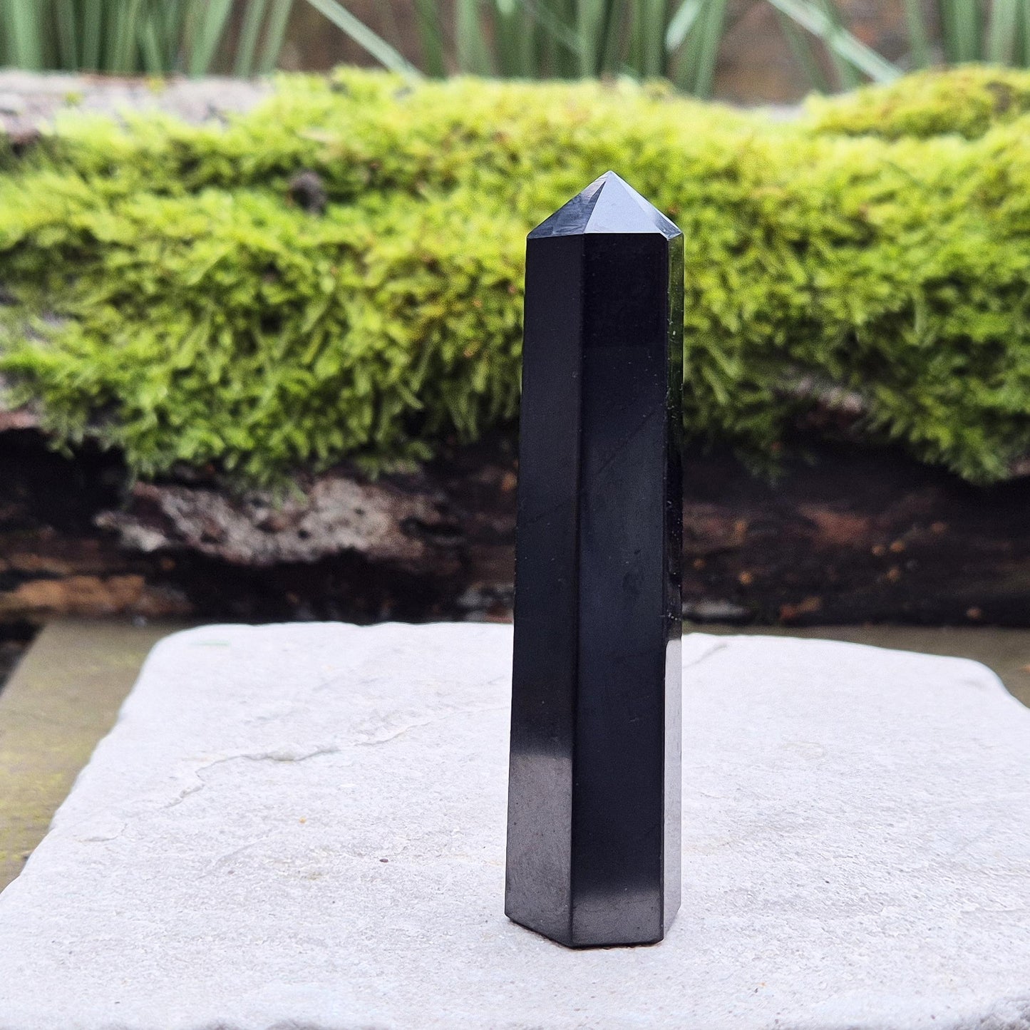 Discover the power of Shungite! This polished point helps create a peaceful environment, perfect for crystal lovers seeking balance and energy protection.