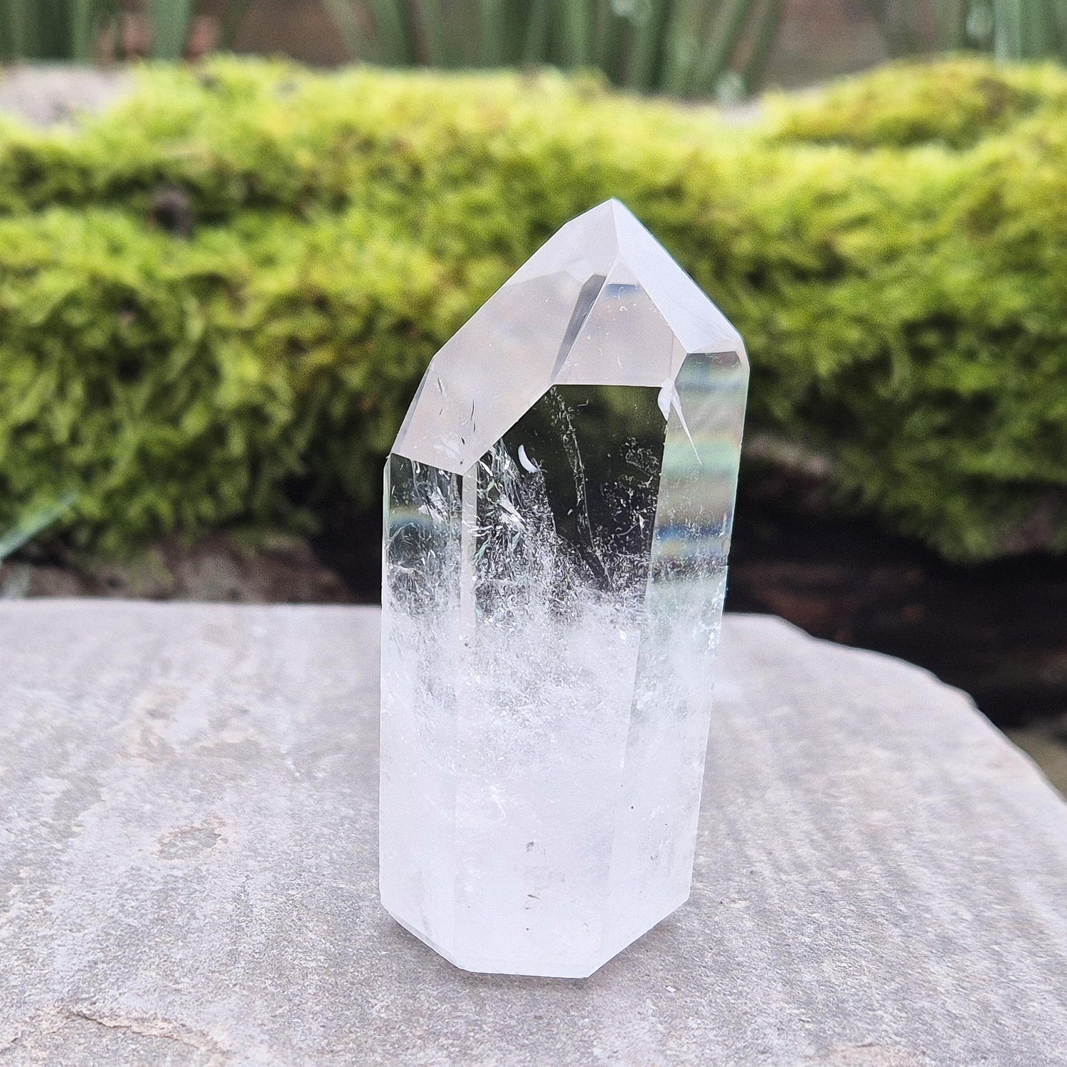 Quartz Crystal Point with 2 non symmetrical isis faces from Brazil. This is a wonderfully point with lovely clarity middle to tip and wispy clouds towards the base. A grade.