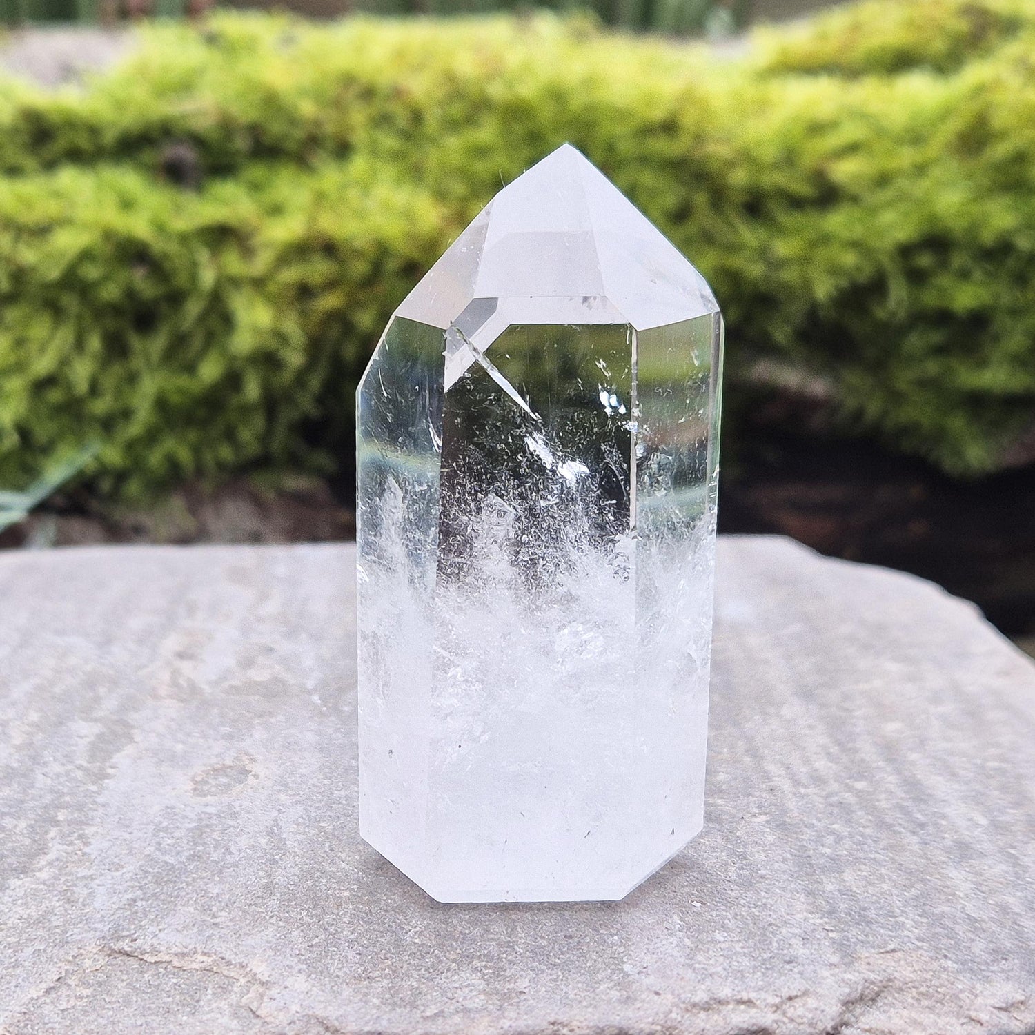 Quartz Crystal Point with 2 non symmetrical isis faces from Brazil. This is a wonderfully point with lovely clarity middle to tip and wispy clouds towards the base. A grade.