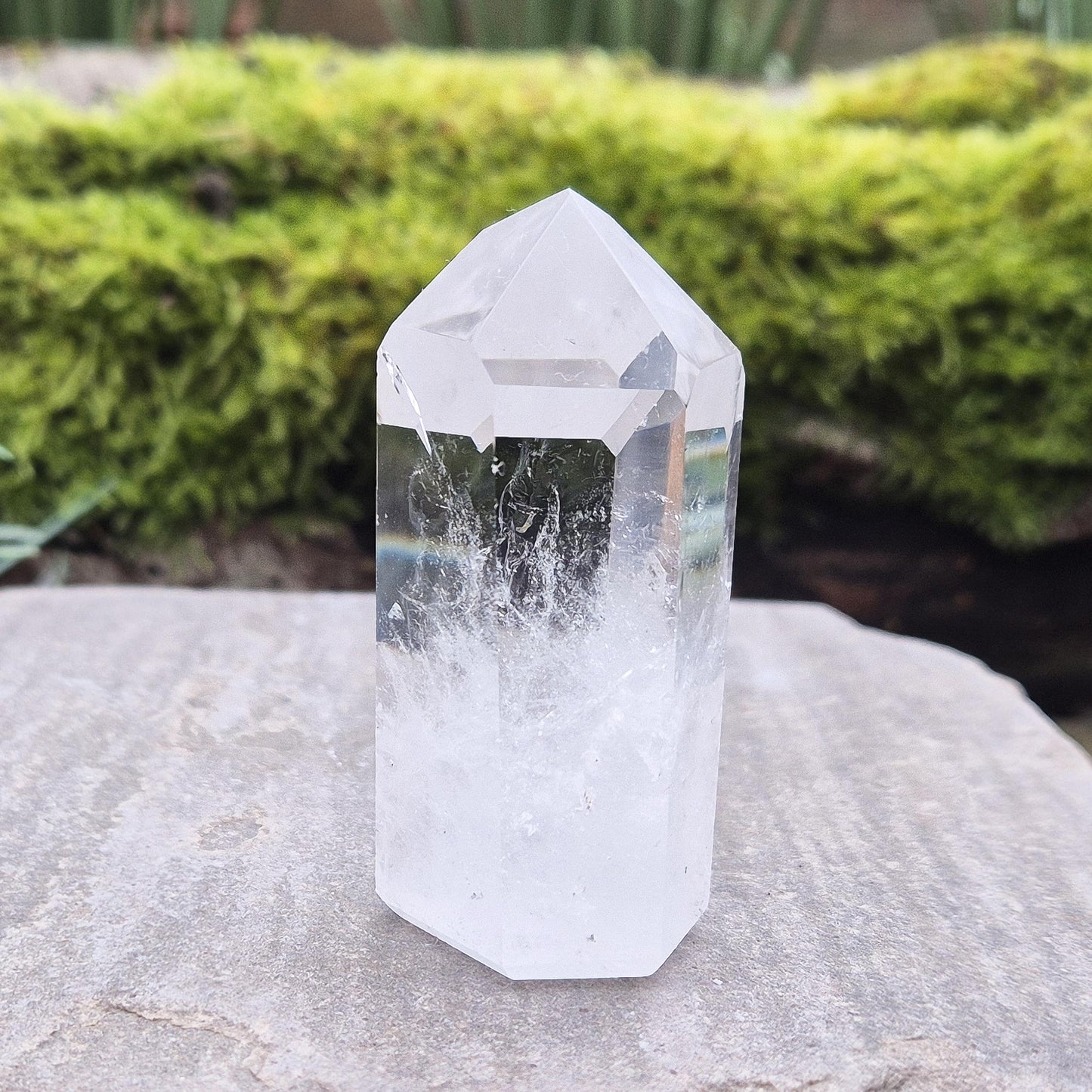 Quartz Crystal Point with 2 non symmetrical isis faces from Brazil. This is a wonderfully point with lovely clarity middle to tip and wispy clouds towards the base. A grade.