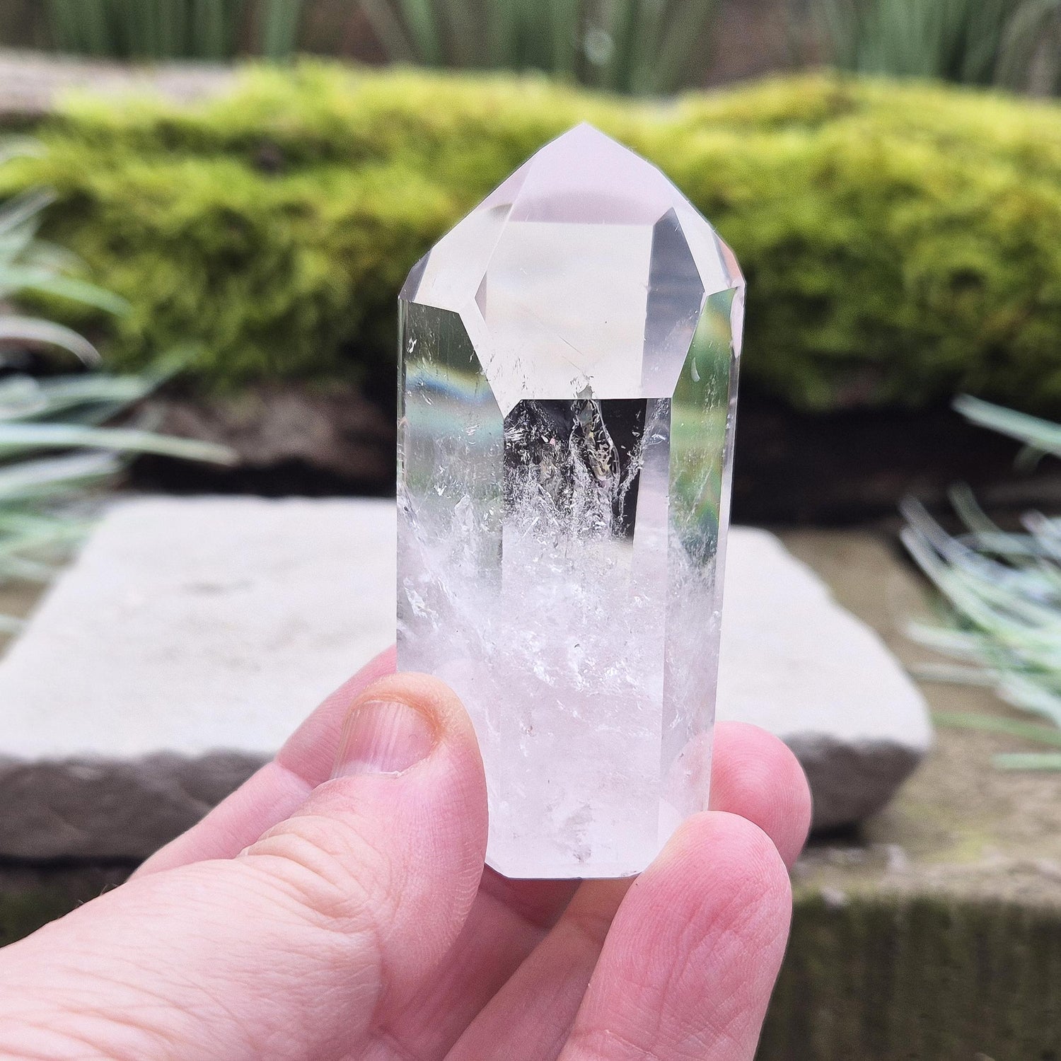 Quartz Crystal Point with 2 non symmetrical isis faces from Brazil. This is a wonderfully point with lovely clarity middle to tip and wispy clouds towards the base. A grade.