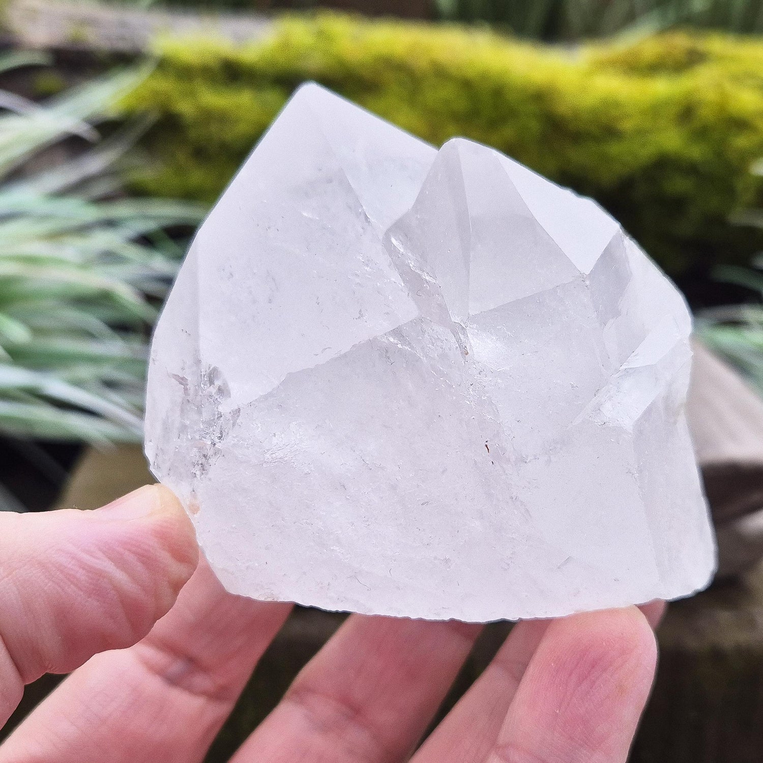 Quartz Crystal Cluster. From Brazil. This cluster comprises of one larger point, a smaller point, and then a companion crystal embedded into the smaller of the 2 points. Will self stand. Base a lovely shine/shimmer to it.