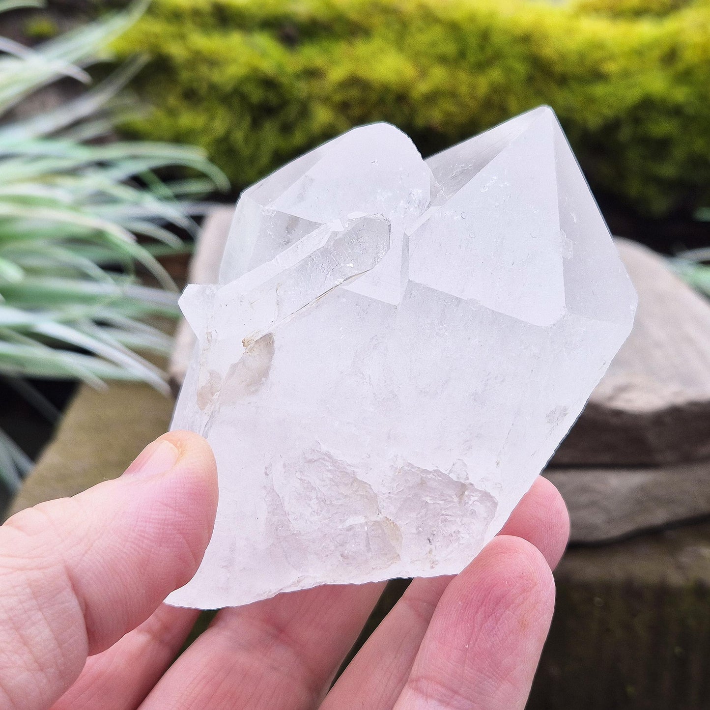 Quartz Crystal Cluster. From Brazil. This cluster comprises of one larger point, a smaller point, and then a companion crystal embedded into the smaller of the 2 points. Will self stand. Base a lovely shine/shimmer to it.