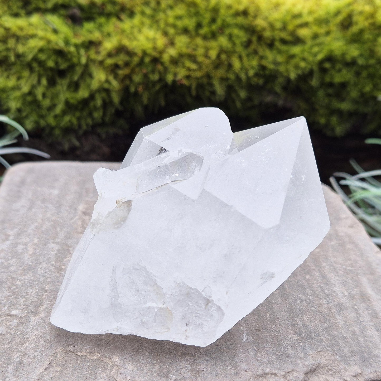 Quartz Crystal Cluster. From Brazil. This cluster comprises of one larger point, a smaller point, and then a companion crystal embedded into the smaller of the 2 points. Will self stand. Base a lovely shine/shimmer to it.