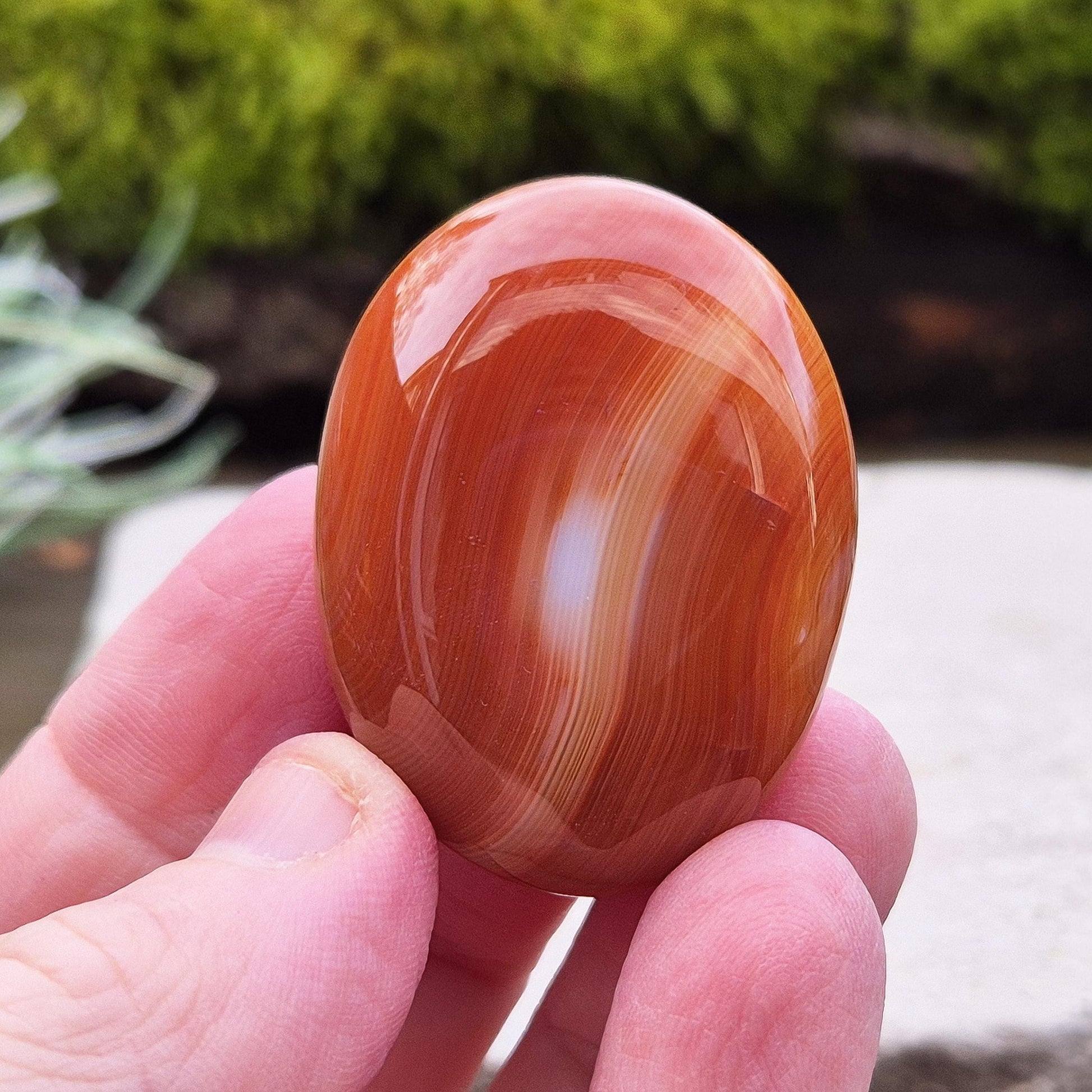 Carnelian Crystal Palm Stone. From Madagascar. This palm stone has a wonderful orange and white banded colouring.