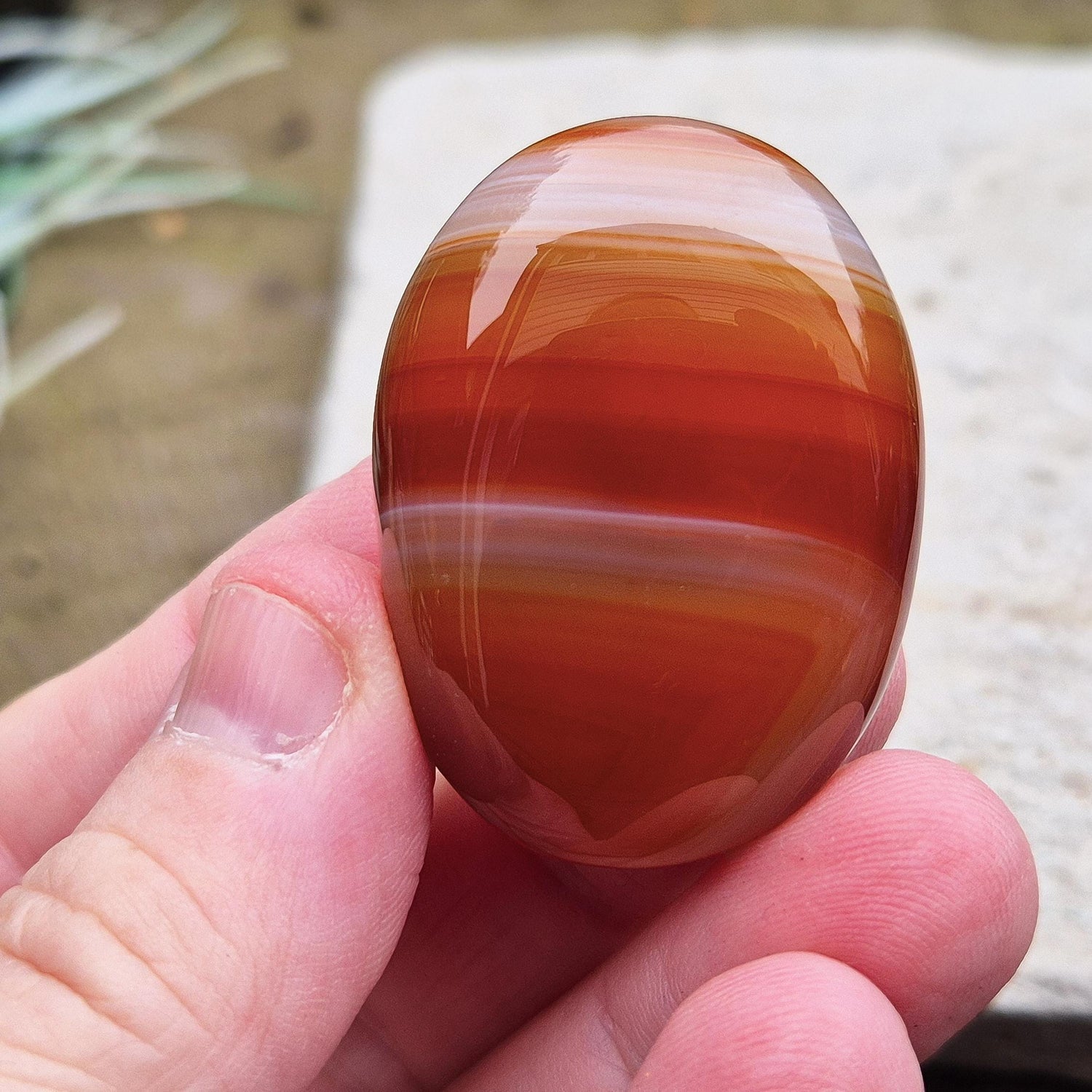 Carnelian Crystal Palm Stone. From Madagascar. This palm stone has a wonderful orange and white banded colouring.