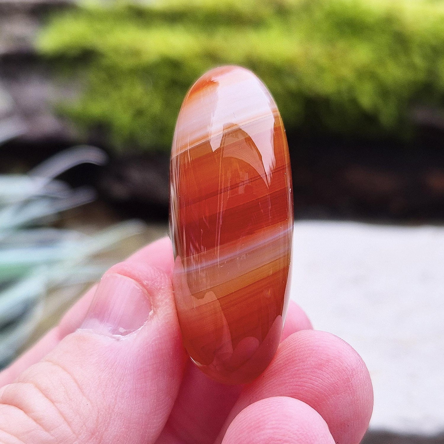 Carnelian Crystal Palm Stone. From Madagascar. This palm stone has a wonderful orange and white banded colouring.