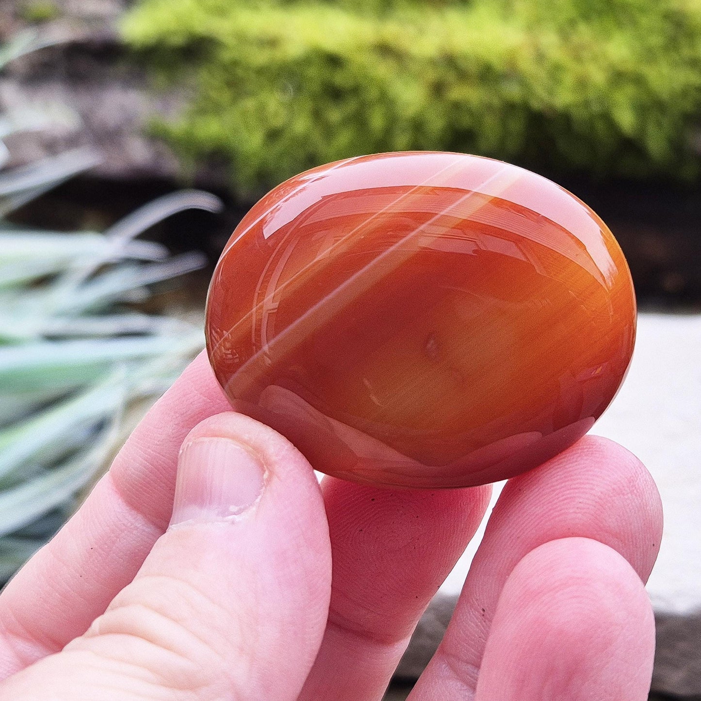 Carnelian Crystal Palm Stone. From Madagascar. This palm stone has a wonderful orange colour and some banding.