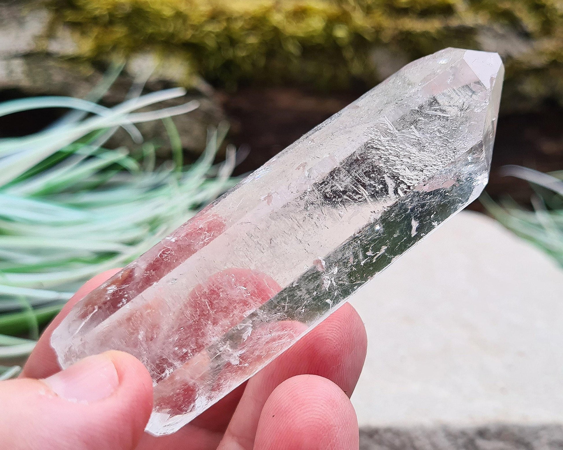 Starbrary Quartz Crystal Point from Brazil. This piece has lovely clarity, distinctive markings, and light-reflecting inclusions.