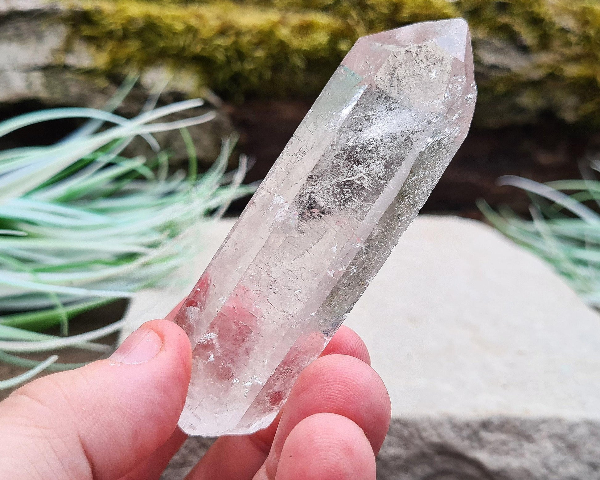Starbrary Quartz Crystal Point from Brazil. This piece has lovely clarity, distinctive markings, and light-reflecting inclusions.