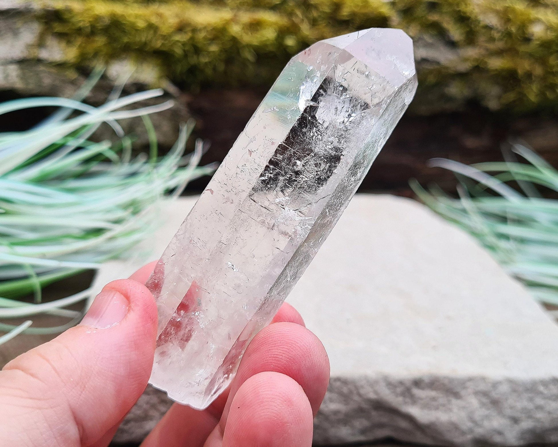Starbrary Quartz Crystal Point from Brazil. This piece has lovely clarity, distinctive markings, and light-reflecting inclusions.