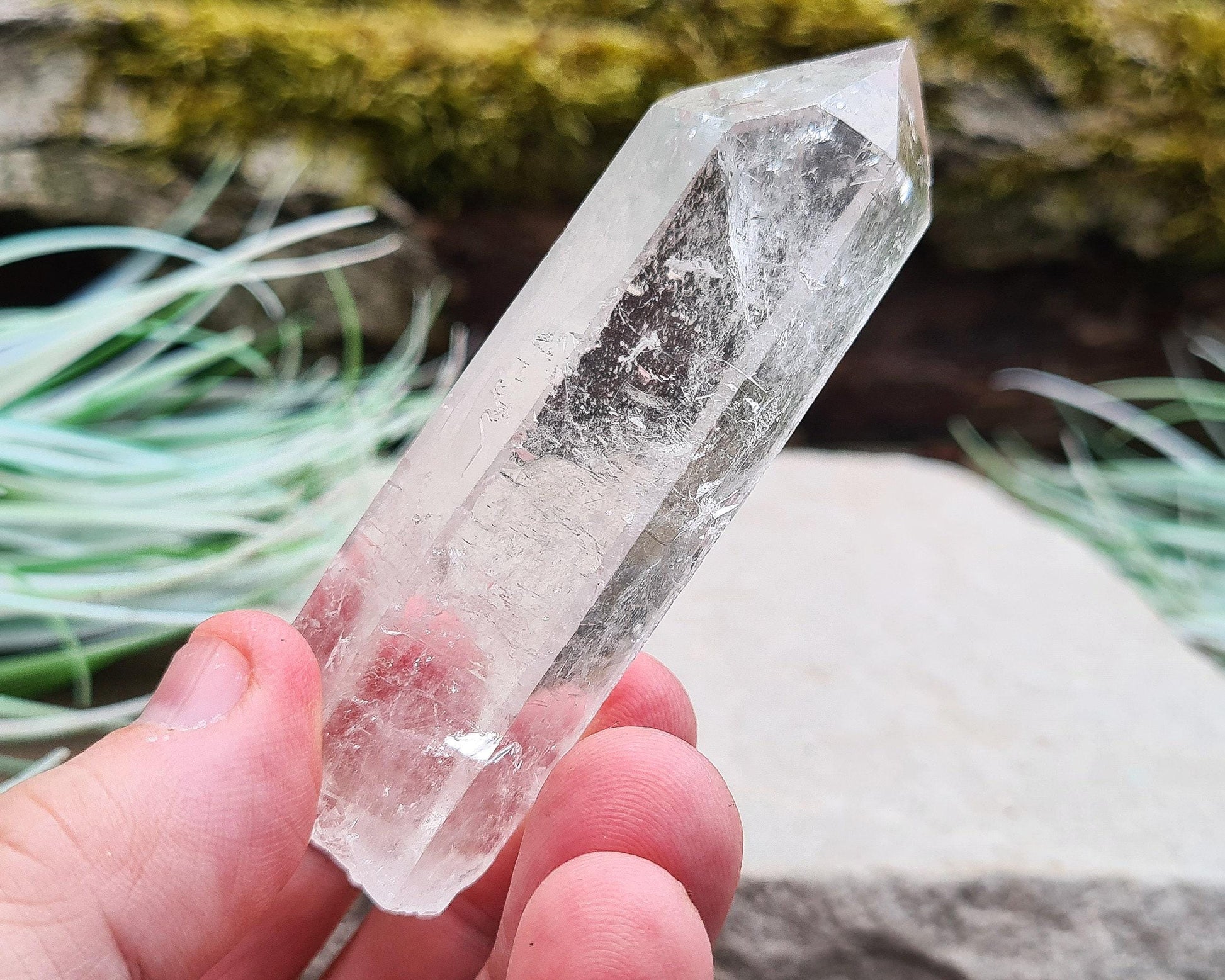 Starbrary Quartz Crystal Point from Brazil. This piece has lovely clarity, distinctive markings, and light-reflecting inclusions.