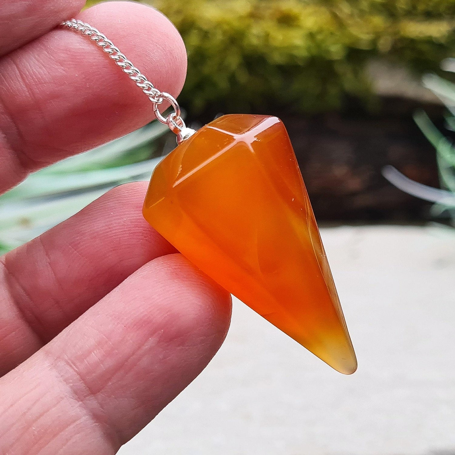 Carnelian Crystal Pendulum. From Madagascar. This pendulum has great orange colouring, and it has a druzy pocket towards the tip which is really unusual. 