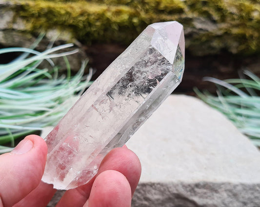 Starbrary Quartz Crystal Point from Brazil. This piece has lovely clarity, distinctive markings, and light-reflecting inclusions.