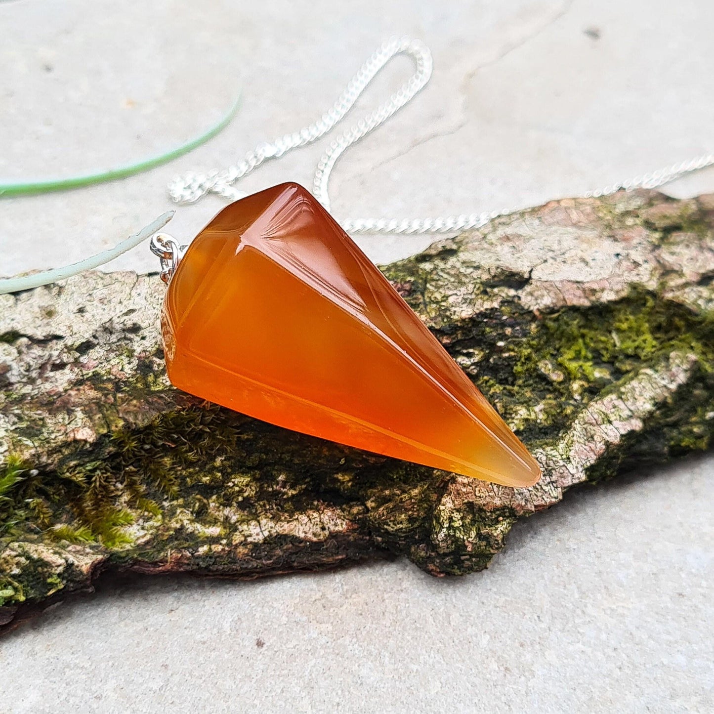 Carnelian Crystal Pendulum, comes with a box or organza pouch to keep it in.