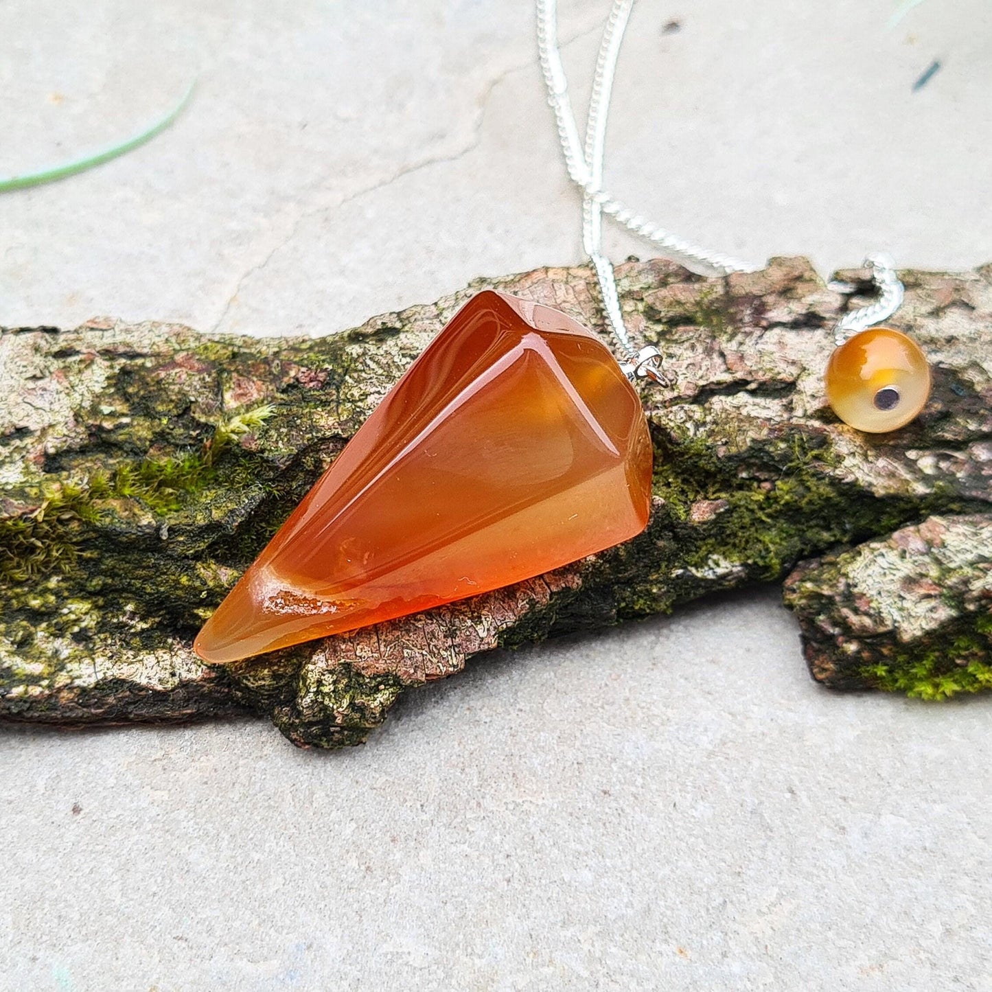 Carnelian Crystal Pendulum, comes with a box or organza pouch to keep it in.