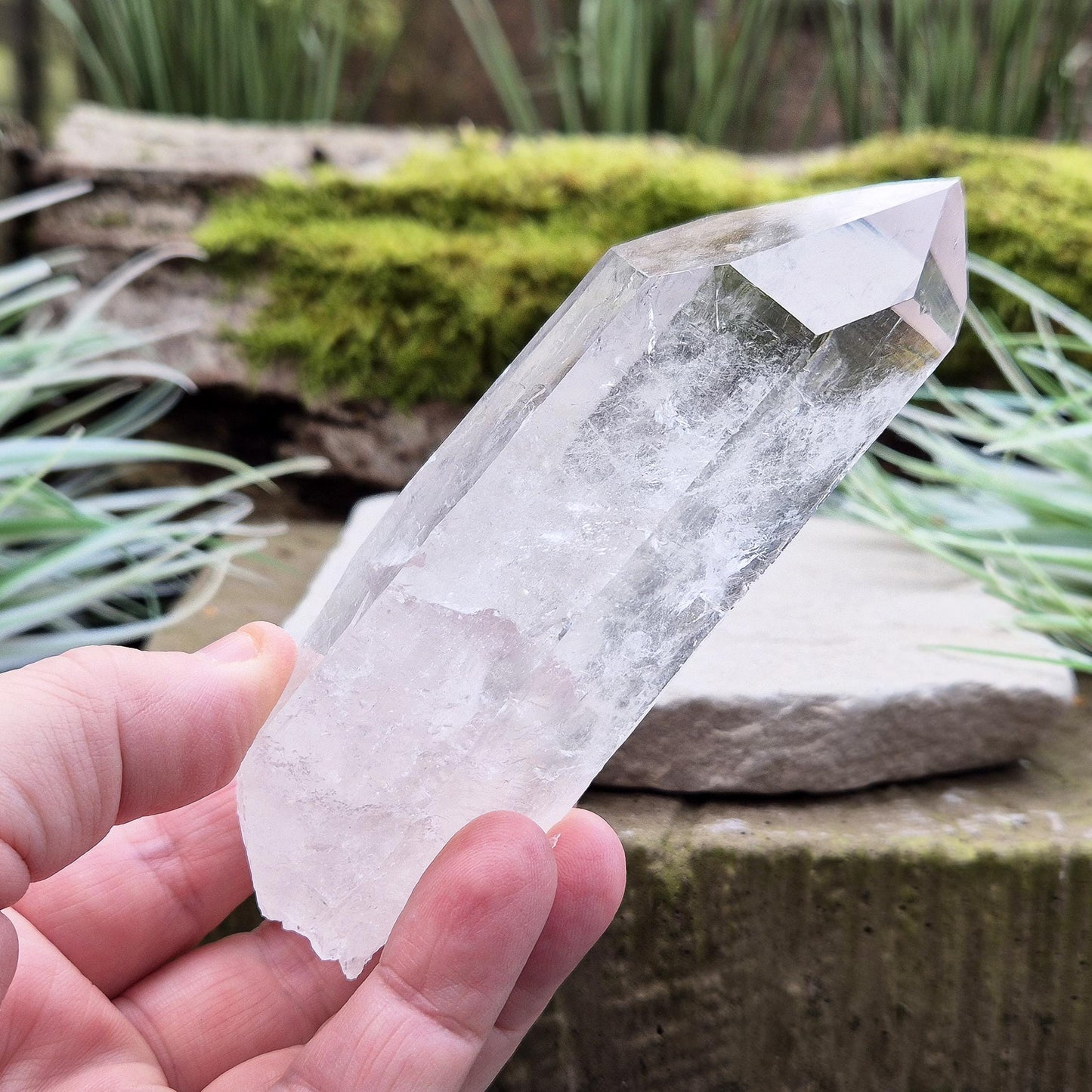 Quartz Crystal Point. From Brazil. This is a wonderfully natural quartz point with wispy inclusions and nice clear clarity towards the top of this point.