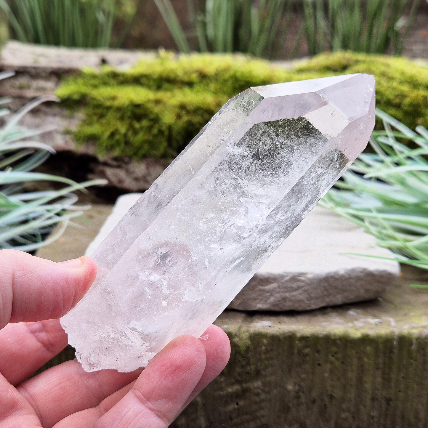 Quartz Crystal Point. From Brazil. This is a wonderfully natural quartz point with wispy inclusions and nice clear clarity towards the top of this point.