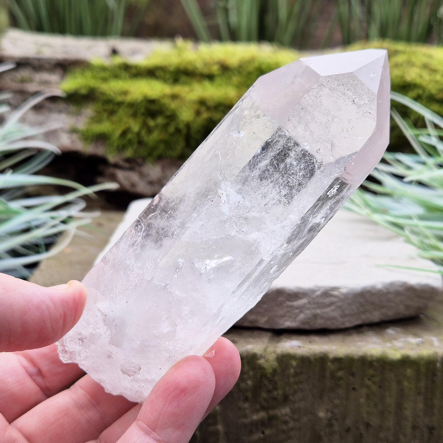 Quartz Crystal Point. From Brazil. This is a wonderfully natural quartz point with wispy inclusions and nice clear clarity towards the top of this point.