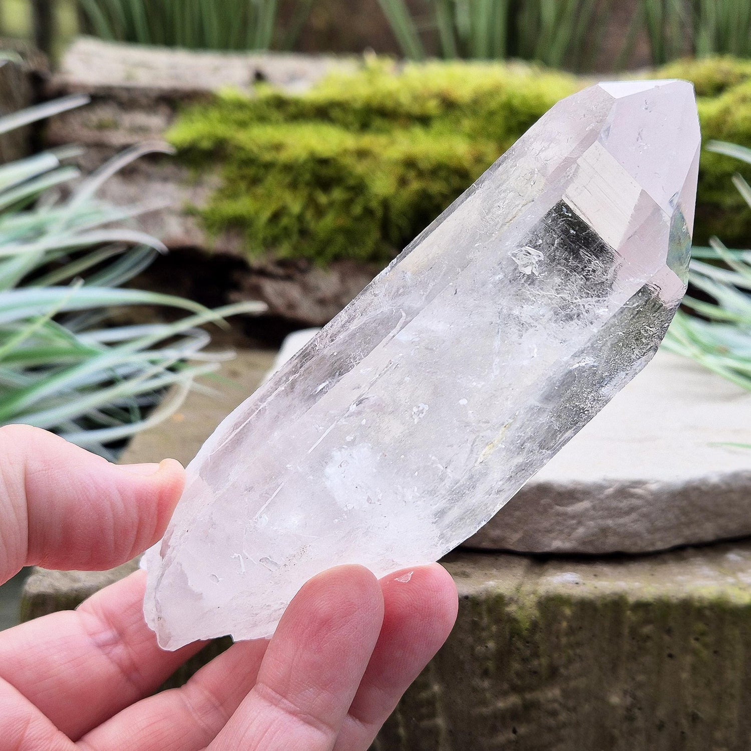 Quartz Crystal Point. From Brazil. This is a wonderfully natural quartz point with wispy inclusions and nice clear clarity towards the top of this point.