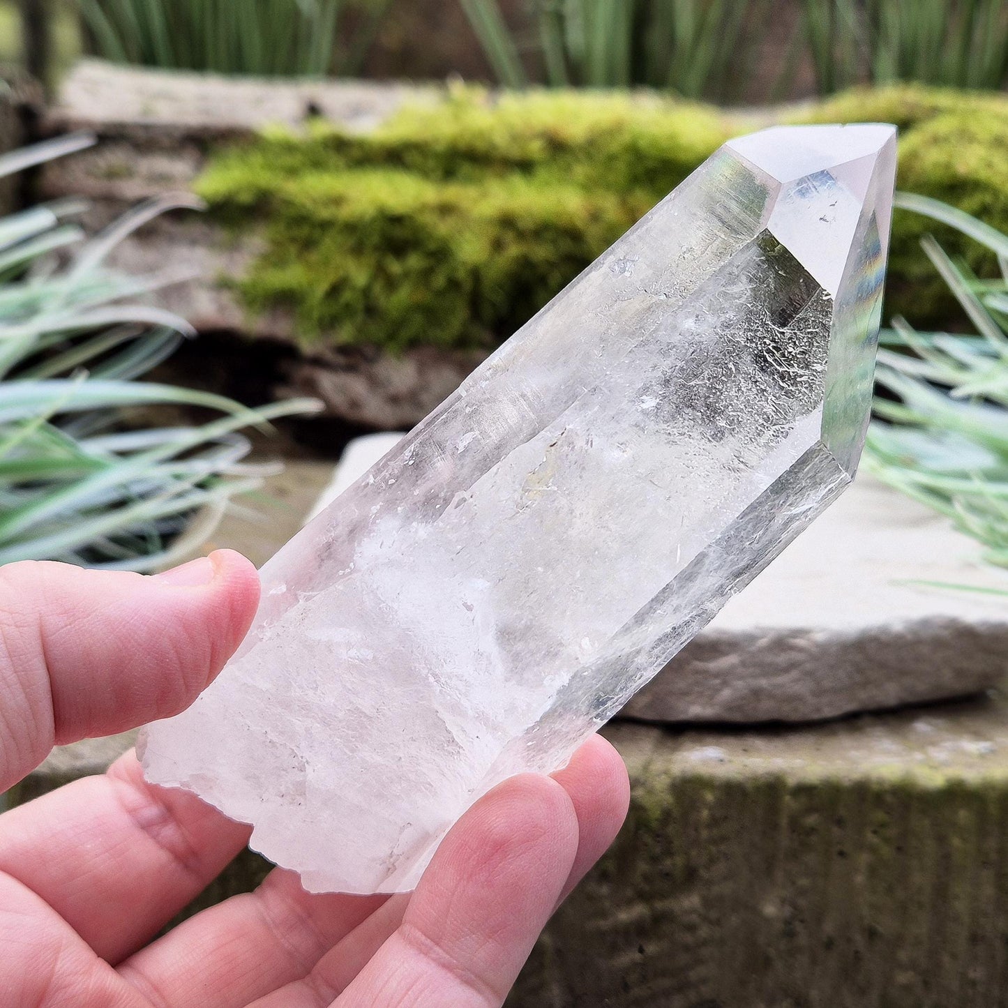 Quartz Crystal Point. From Brazil. This is a wonderfully natural quartz point with wispy inclusions and nice clear clarity towards the top of this point.