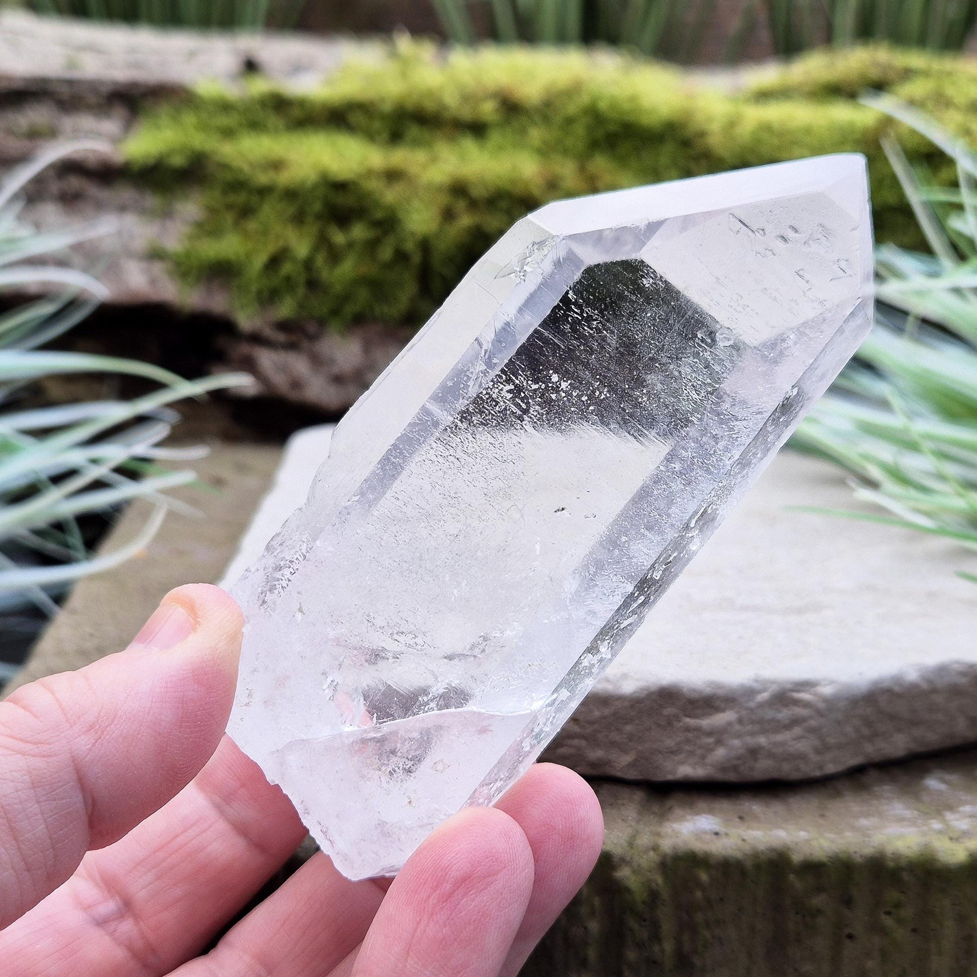 Quartz Crystal Point. From Brazil. This is a wonderfully natural quartz point with wispy inclusions and nice clear clarity towards the top of this point. This crystal point offers an authentic, natural touch to any collection.