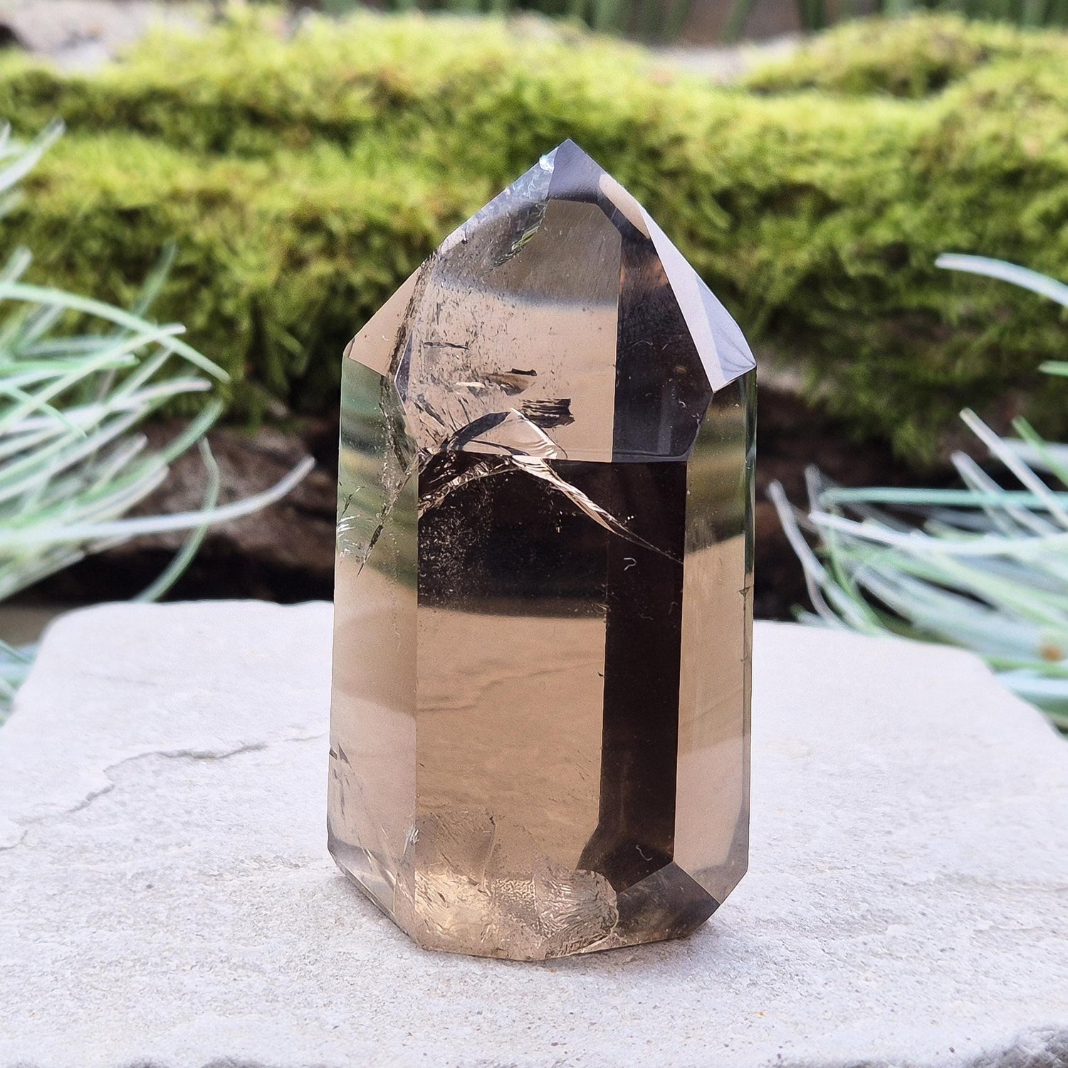 Smoky Quartz Point from Brazil. Natural dark Smoky Quartz polished point. This point has been cut and polished in Brazil. This piece has light reflecting inclusions. 