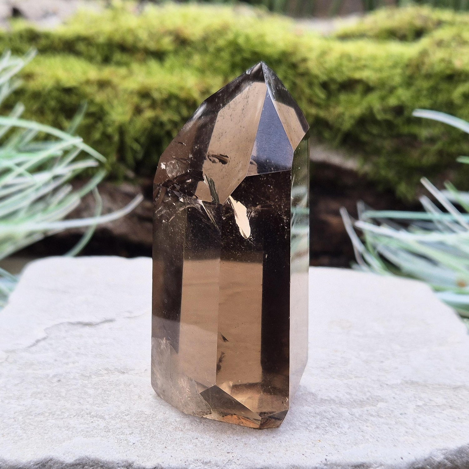 Smoky Quartz Point from Brazil. Natural dark Smoky Quartz polished point. This point has been cut and polished in Brazil. This piece has light reflecting inclusions. 