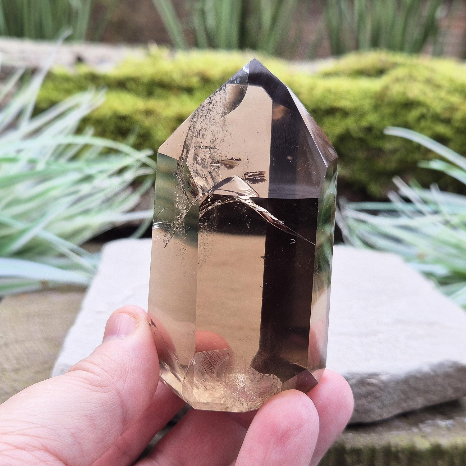 Smoky Quartz Point from Brazil. Natural dark Smoky Quartz polished point. This point has been cut and polished in Brazil. This piece has light reflecting inclusions. 