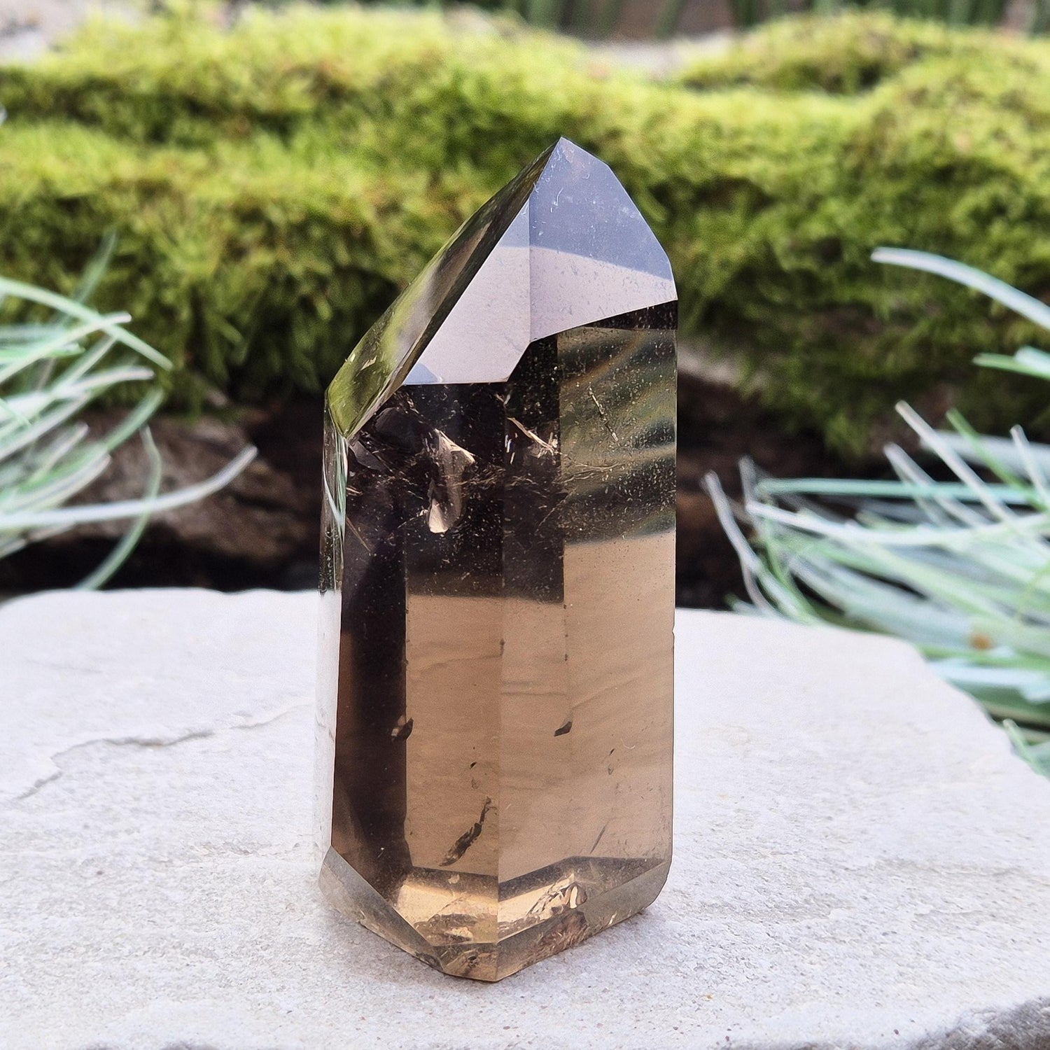 Smoky Quartz Point from Brazil. Natural dark Smoky Quartz polished point. This point has been cut and polished in Brazil. This piece has light reflecting inclusions. 