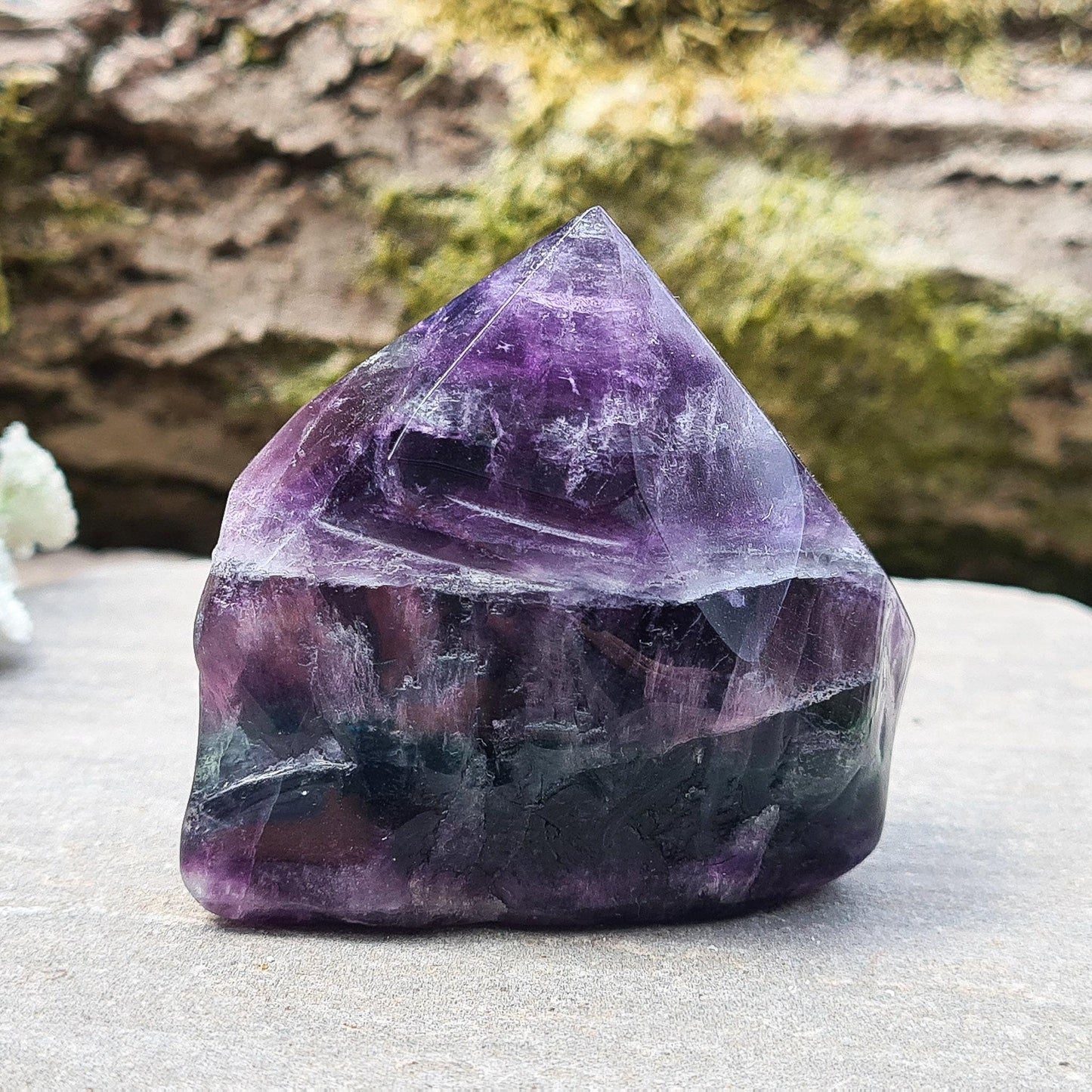 Fluorite Crystal Point. Lovely green and purple colouring. Point is a polished 6 sided, base is also polished and the sides are more natural looking and looks to have been slightly polished.