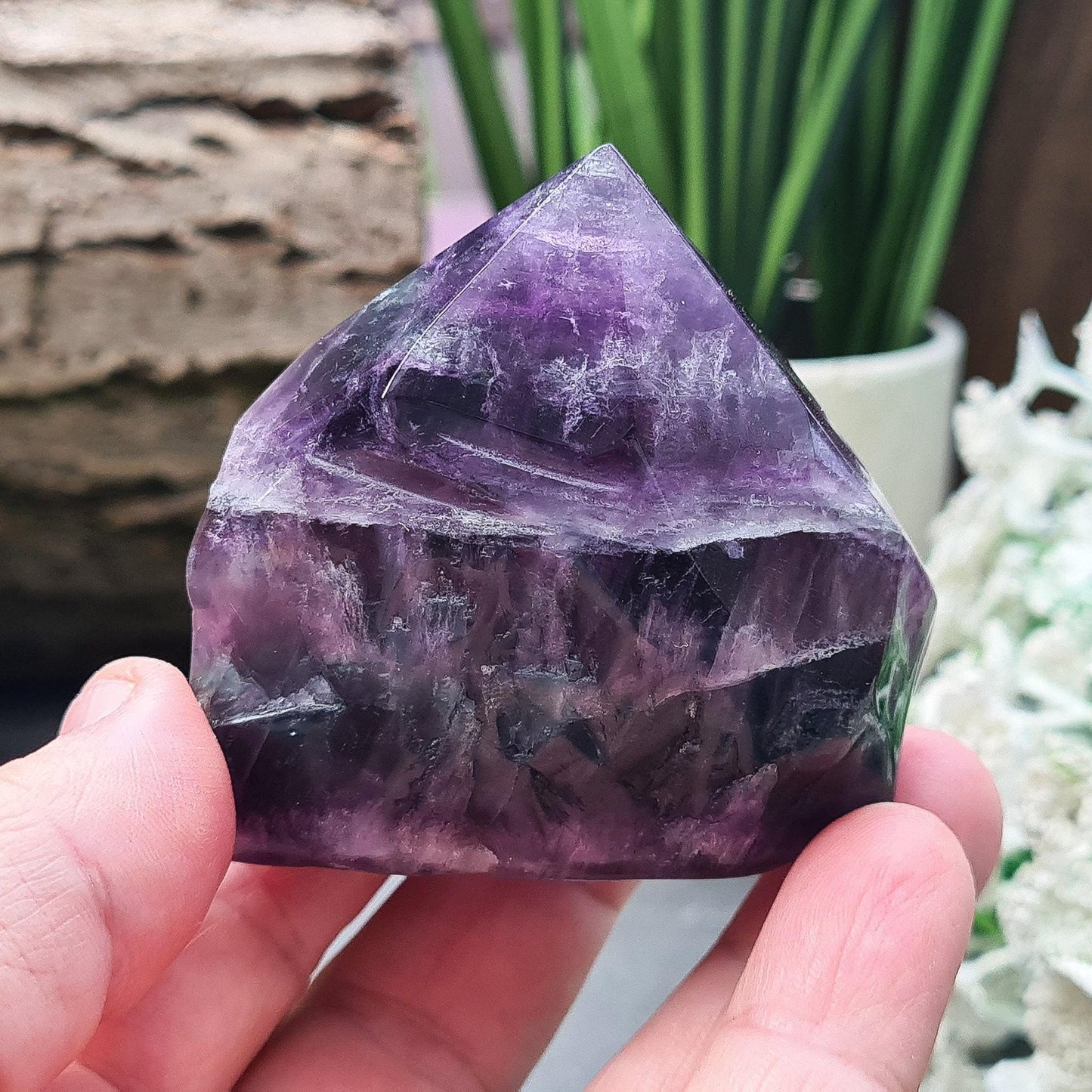 Fluorite Crystal Point. Lovely green and purple colouring. Point is a polished 6 sided, base is also polished and the sides are more natural looking and looks to have been slightly polished.