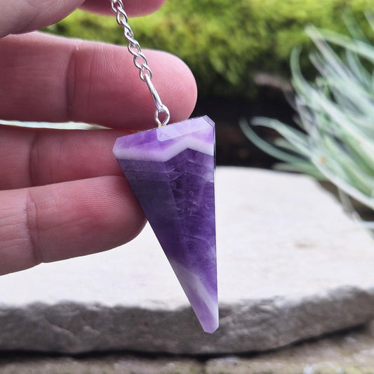 Chevron Amethyst Crystal Pendulum with a purple bead at the end of the chain. It will come with an organza pouch to keep it in. 