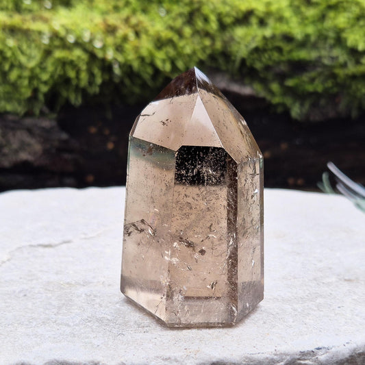 Smoky Quartz Point from Brazil. Natural dark Smoky Quartz polished point. This point has been cut and polished in Brazil. This piece has light reflecting and wispy inclusions. 