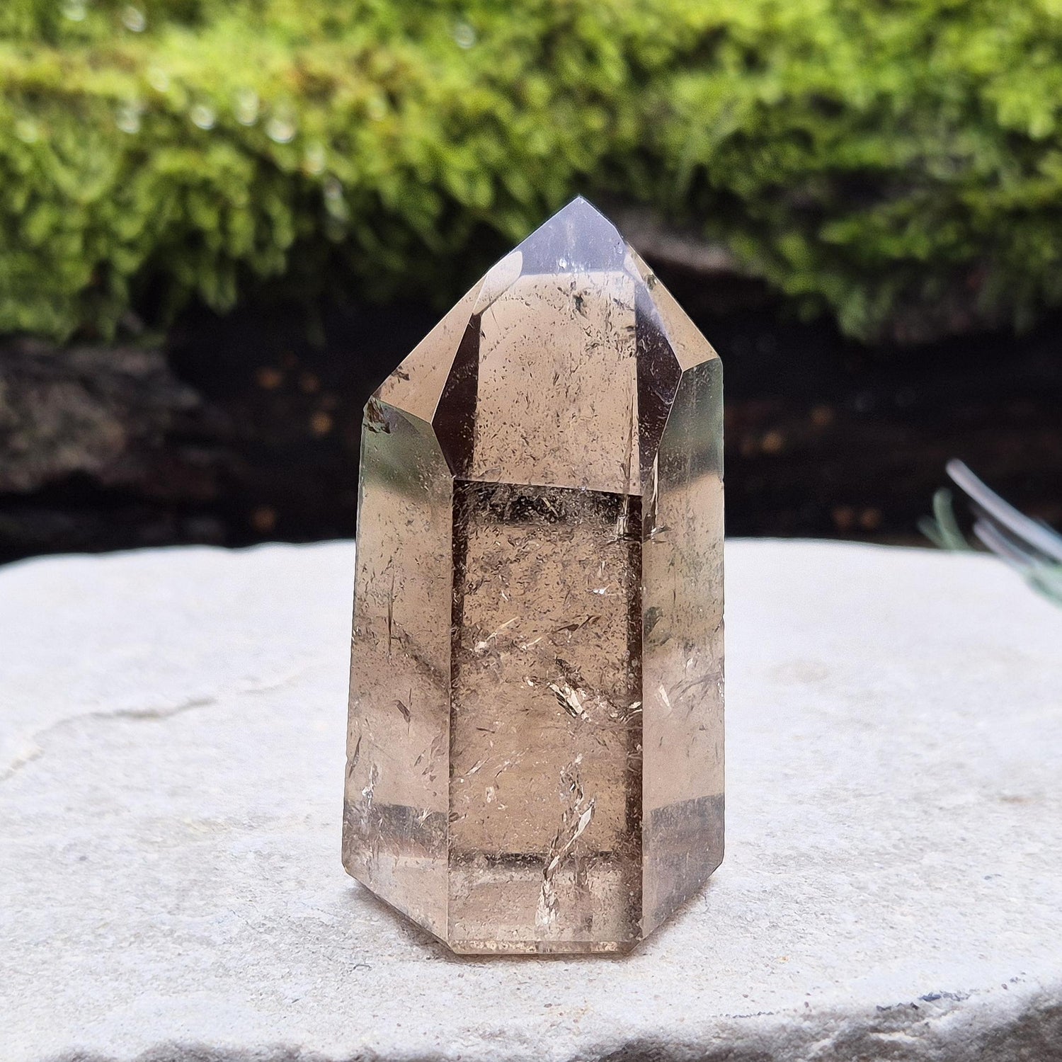 Smoky Quartz Point from Brazil. Natural dark Smoky Quartz polished point. This point has been cut and polished in Brazil. This piece has light reflecting and wispy inclusions. 