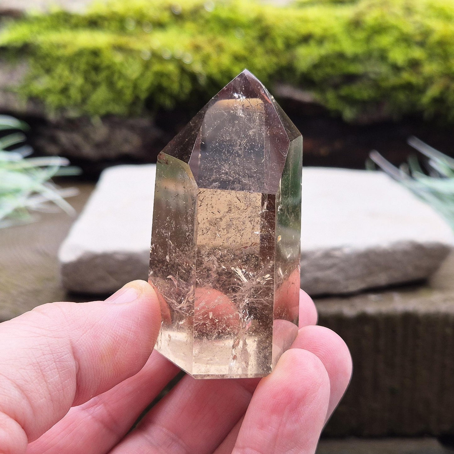 Smoky Quartz Point from Brazil. Natural dark Smoky Quartz polished point. This point has been cut and polished in Brazil. This piece has light reflecting and wispy inclusions. 