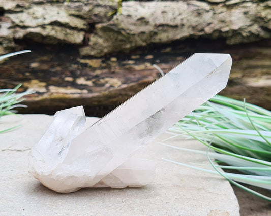 Madagascan Quartz Crystal Cluster with 1 large point and a couple of smaller points at its base. It will self stand.