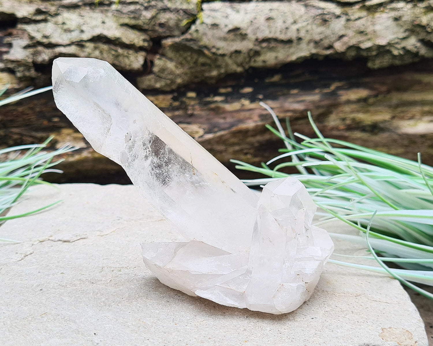 Madagascan Quartz Crystal Cluster with 1 large point and a couple of smaller points at its base. It will self stand.