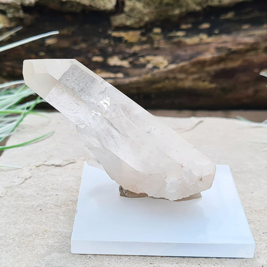 Madagascan Quartz Crystal Cluster with 1 large point and a few smaller points at its base. It will not self stand so I will supply some putty and a small square base that it can be mounted on.