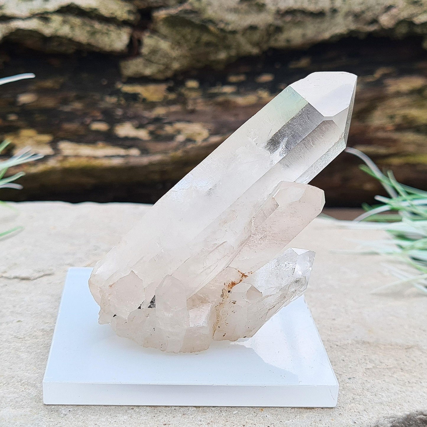 Madagascan Quartz Crystal Cluster with 1 large point and a few smaller points at its base. It will not self stand so I will supply some putty and a small square base that it can be mounted on.