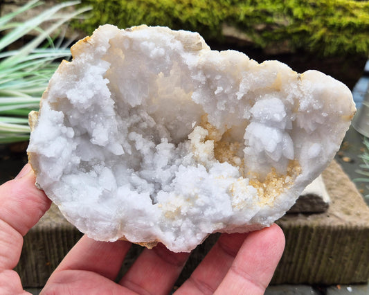 White Quartz Crystal Geode Half, from Morocco. Lovely sparkling white quartz crystal formations. It can sit on an even surface by itself.